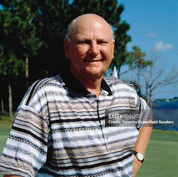 Business tycoon Wayne Huizenga on the putting green of a waterfront golf course.