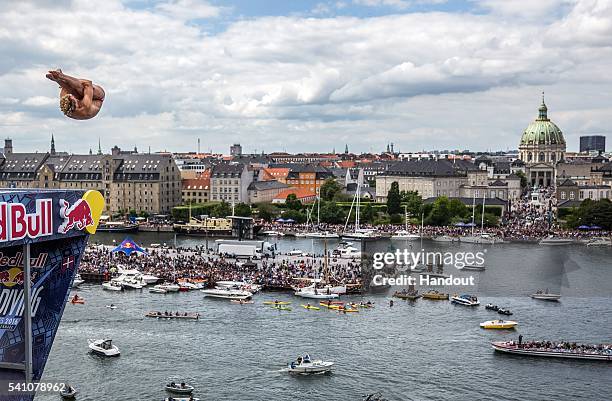 In this handout image provided by Red Bull, Kris Kolanus of Poland dives from the 28 metre platform on the Copenhagen Opera House during the second...