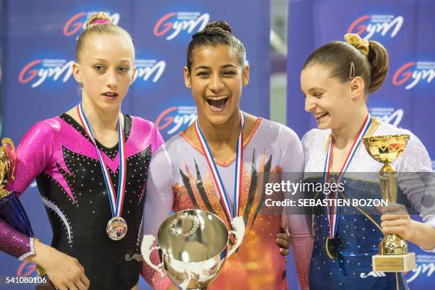 Juliette Bossu , Marine Boyer and Anne Kuhm pose on the podium during the French artistic gymnastic championship on June 18 in Mulhouse, eastern...
