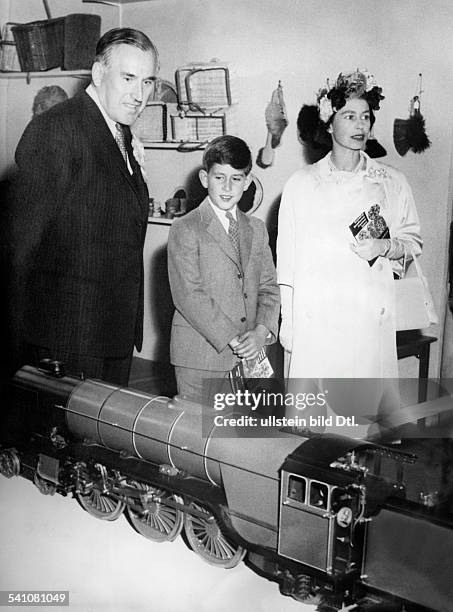 Elisabeth II. *-Koenigin von GB seit 1953- betrachtet mit ihrem Sohn und Thronfolger Prinz Charles eine Modelleisenbahn
