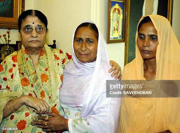 Kamala Advani , wife of India's Bharatiya Janata Party President comforts Dalbir Kaur and Sukhpreet Kaur sister and wife of Sarabjit Singh, an Indian...