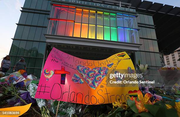 Makeshift memorial to victims of the Pulse nightclub shooting continues to grow in front of the Dr. Phillips Center for the Performing Arts in...