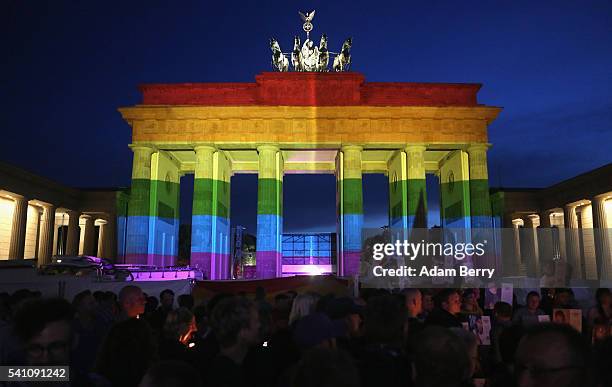 The Brandenburg Gate is seen with a rainbow flag projected onto it during a vigil for victims of a shooting at a gay nightclub in Orlando, Florida...