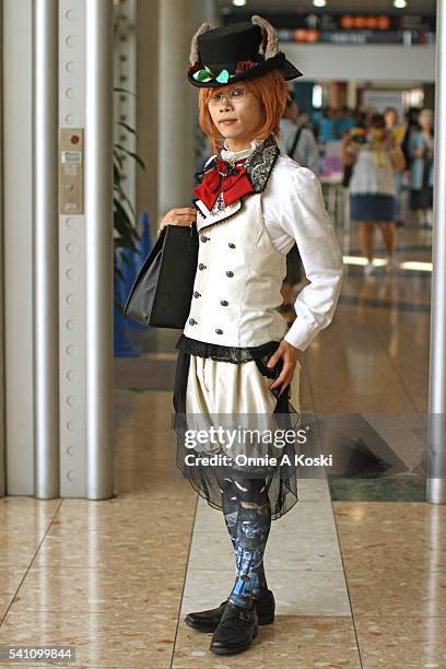 Seiya is wearing a black top hat with animal ears and rose accent, a white four buttoned double-breasted vest with black lace collar, a red bow with...