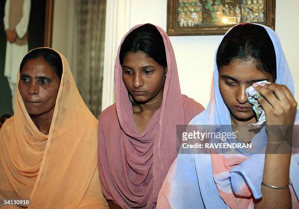 Indian woman Sukhpreet Kaur wife of Sarabjit Singh, an Indian national held and sentenced to hang in Pakistan, poses with her daughters Poonam and...