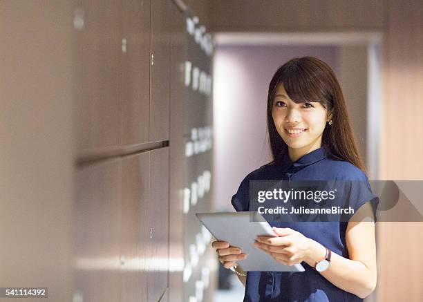 smiling office worker with digital tablet - file clerk stock pictures, royalty-free photos & images