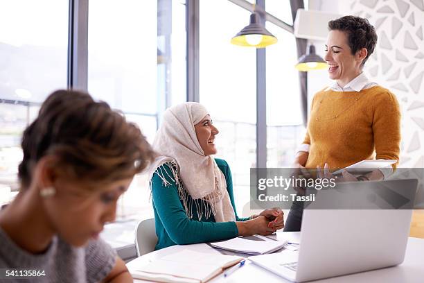 they like to keep their meetings light hearted - muslim women group stock pictures, royalty-free photos & images