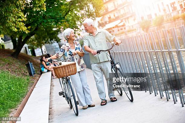 seniorenpaar im einer stadt ljubljana - shopping with bike stock-fotos und bilder