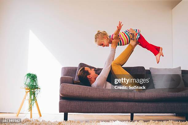 she is flying high! - lying on back girl on the sofa stock pictures, royalty-free photos & images