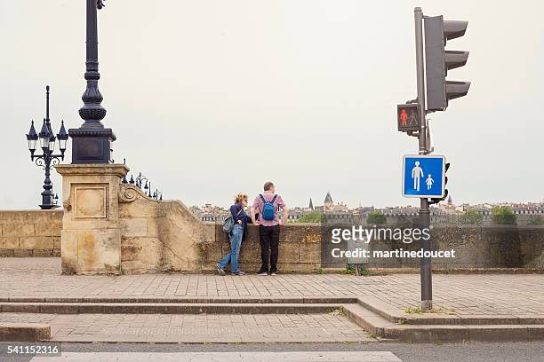 mature couple of tourists looking at the view on bridge. - bordeaux street stock pictures, royalty-free photos & images