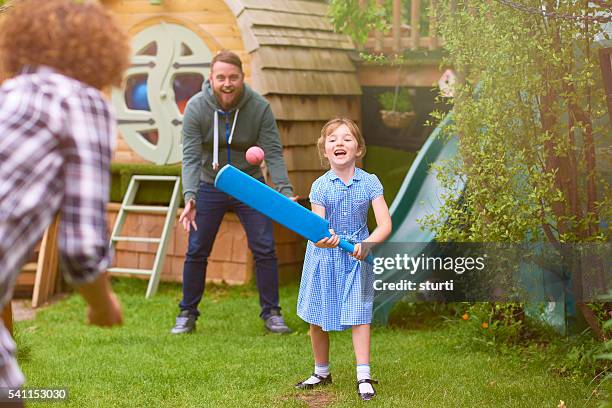 female cricketer with family in the garden - kids cricket stock pictures, royalty-free photos & images