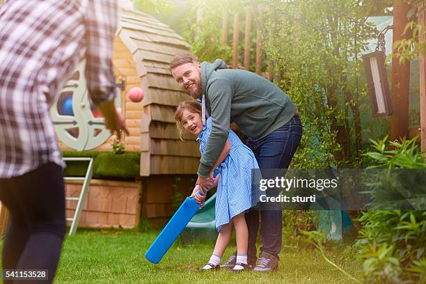 father teaching daughter - family cricket stockfoto's en -beelden