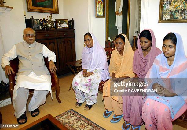 India's Bharatiya Janata Party President Lal Krishna Advani speaks with Dalbir Kaur and Sukhpreet Kaur , sister and wife of Sarabjit Singh, an Indian...