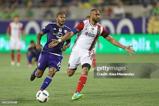 Victor Bernardez of San Jose Earthquakes blocks Julio Baptista of Orlando City SC as he runs toward his goalkeeper during an MLS soccer match between...