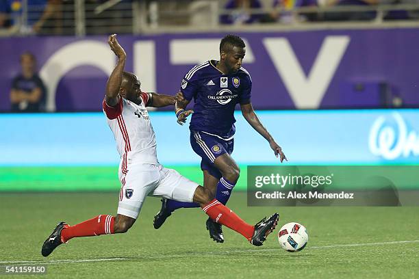 Kevin Molino of Orlando City SC gets tackled by Victor Bernardez of San Jose Earthquakesduring an MLS soccer match between the San Jose Earthquakes...