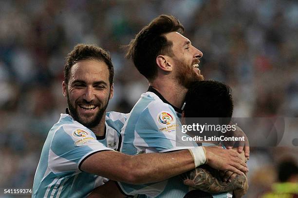 Lionel Messi celebrates with teammates Gonzalo Higuain and Nicolas Gaitan after scoring the third goal of the game during a Quarterfinal match...