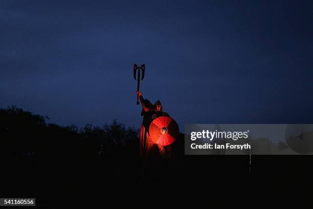 Viking stands on top of a hill during a battle as participants perform in a full dress rehearsal preview evening for the Kynren event, an epic tale...