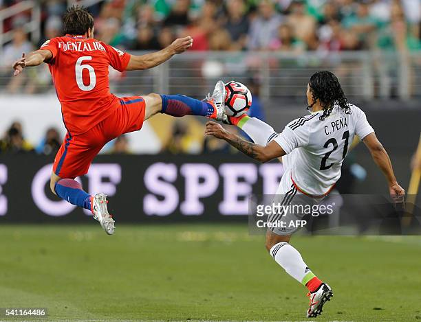 Mexico's Carlos Pena vies for the ball with Chile's Jose Fuenzalida during a Copa America Centenario quarterfinal football match in Santa Clara,...