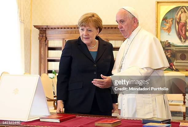 Pope Francis meeting Angela Merkel , Chancellor of the Federal Republic of Germany, in the private library of Palazzo Apostolico. Vatican City, 6th...