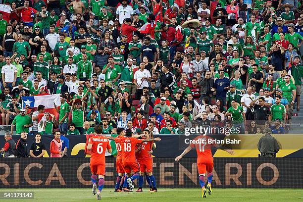 Eduardo Vargas of Chile gets swarmed by Charles Aranguiz, Gonzalo Jara, and Edson Puch after scoring the fourth goal of his team Quarterfinal match...