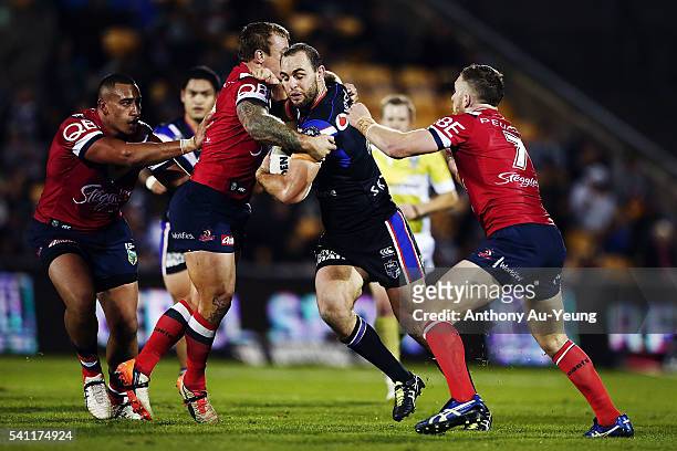 Simon Mannering of the Warriors on the charge against Jake Friend of the Roosters during the round 15 NRL match between the New Zealand Warriors and...