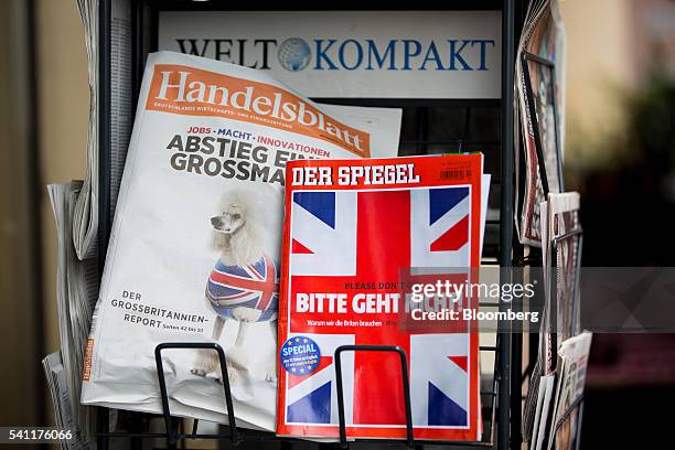 Copy of German magazine Der Spiegel featuring the headline "Please don't go!" and a British Union flag illustration on the cover sits on a rack...