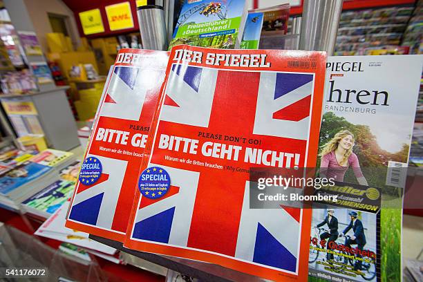 Copies of German magazine Der Spiegel featuring the headline "Please don't go!" and a British Union flag illustration on the cover sit on a rack...
