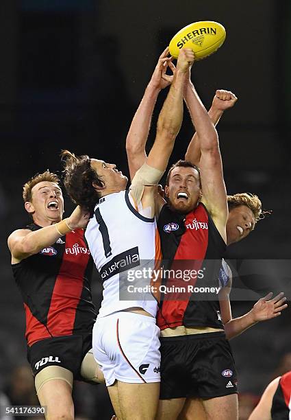 Phil Davis of the Giants spoils a mark by Matthew Leuenberger of the Bombers during the round 13 AFL match between the Essendon Bombers and the...