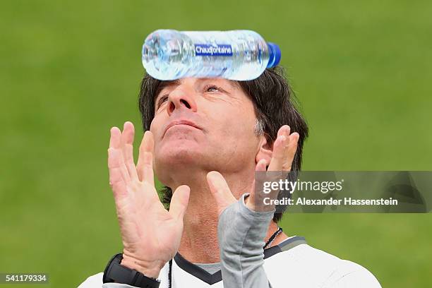 Joachim Loew, head coach of the German national team plays with a mineral water bottle during a Germany training session at Ermitage Evian on June...