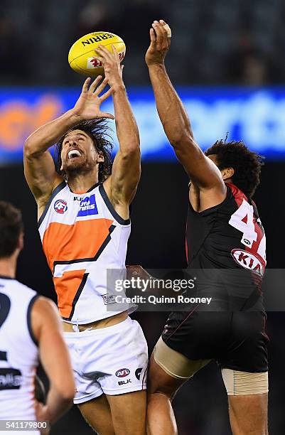 Ryan Griffen of the Giants marks infront of James Gwilt of the Bombers during the round 13 AFL match between the Essendon Bombers and the Greater...