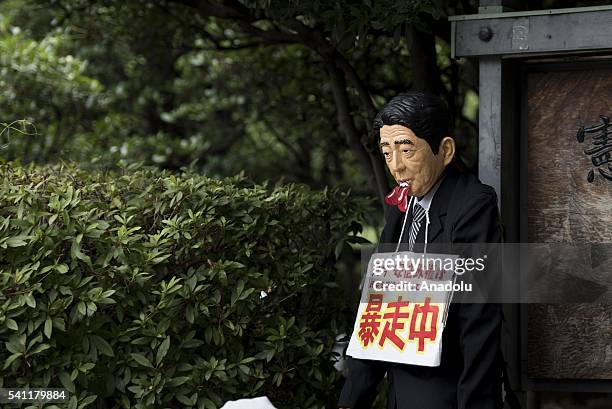 Protester wears Shinzo Abe costume as Anti-U.S. Airbase demonstrators protest the U.S. Airbase relocation to Henoko in front of the Japanese...