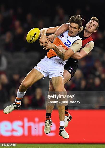 Michael Hartley of the Bombers spoils a mark by Rory Lobb of the Giants during the round 13 AFL match between the Essendon Bombers and the Greater...