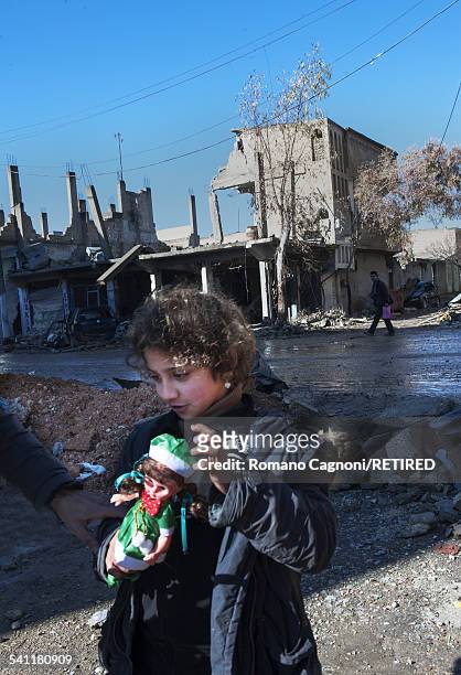 Year-old Morghana Seifadin returns home with her family to the destroyed town of Kobani in Syria, with a doll that was given to her in the refugee...