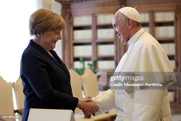 Pope Francis meeting Angela Merkel , Chancellor of the Federal Republic of Germany, in the private library of Palazzo Apostolico. Vatican City, 6th...