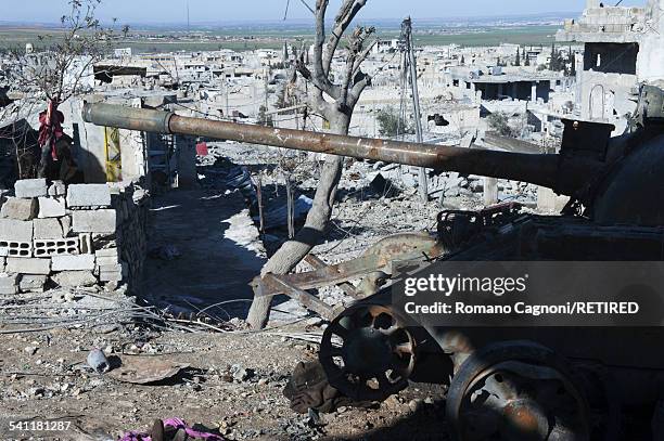 Burnt-out tank overlooks the destroyed town of Kobani, Syria.