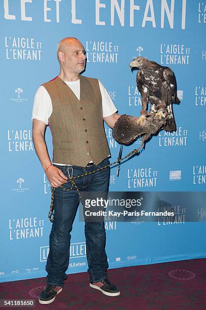 Harry the eagle handler and the eagle attend the 'L Aigle et L Enfant' Photocall at the cinema Gaumont Capucines on June 19, 2016 in Paris, France.