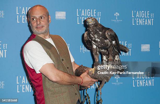 Harry the eagle handler and the eagle attend the 'L Aigle et L Enfant' Photocall at the cinema Gaumont Capucines on June 19, 2016 in Paris, France.