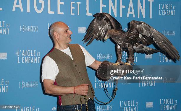 Harry the eagle handler and the eagle attend the 'L Aigle et L Enfant' Photocall at the cinema Gaumont Capucines on June 19, 2016 in Paris, France.