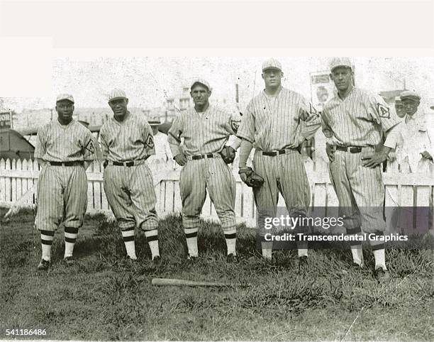 Photographic print of five members of the Almendares baseball club as they pose in Almendares Park, Havana, Cuba, 1931. They are, from left, Cocaina...