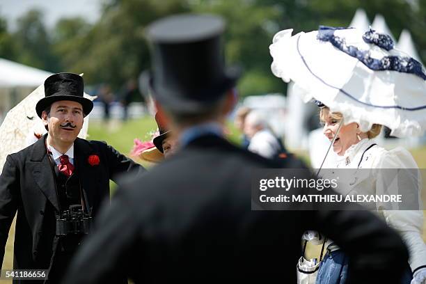 People wearing period costumes, attend the 167th "Prix de Diane", a 2100-metre flat horse race, on June 19, 2016 in Chantilly, north of Paris. / AFP...
