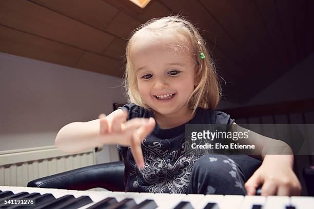 happy child (3-4) playing piano - keyboard instrument stock pictures, royalty-free photos & images