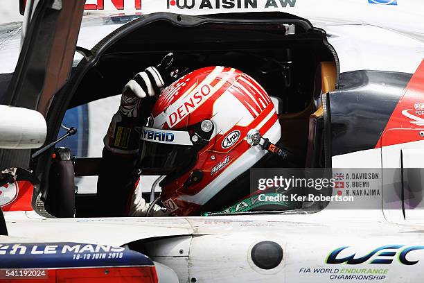 Kazuki Nakajima of Toyota Gazoo Racing reacts in his car after suffering engine problems while leading at the end of the Le Mans 24 Hour race handing...