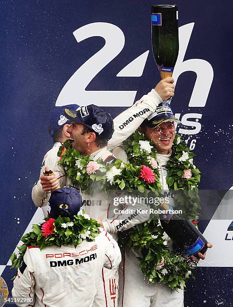 The Porsche Team 919 of Neel Jani , Romain Dumas and Marc Lieb celebrates on the podium after winning the Le Mans 24 Hour race at the Circuit de la...