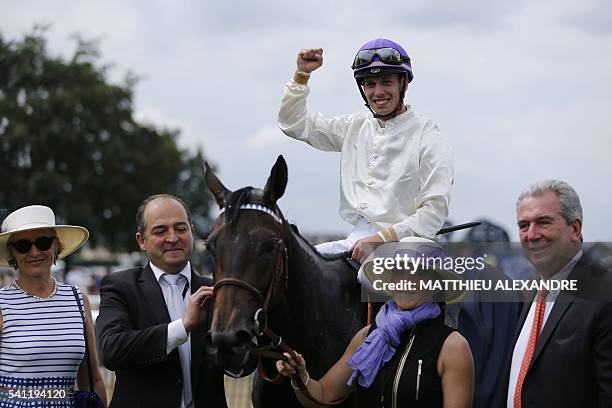 Italian jockey Cristian Demuro , flanked by French horse trainer and former jockey Jean-Claude Rouget , celebrates after coming in first on La...