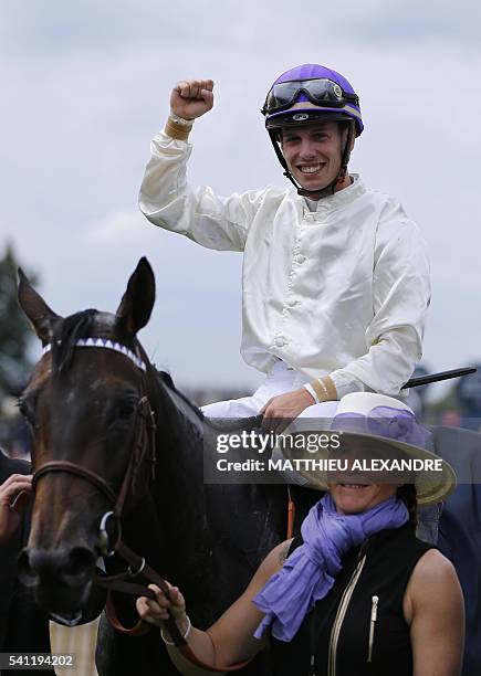 Italian jockey Cristian Demuro celebrates after coming in first on La Cressonniere during the 167th "Prix de Diane", a 2100-metre flat horse race, on...