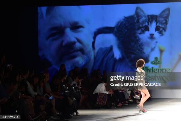 Picture of WikiLeaks founder Julian Assange is seen on a giant screen at the show for fashion house Vivienne Westwood during the Men's Spring -...