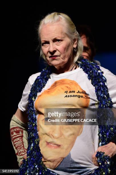 Designer Vivienne Westwood wears a tee-shirt reading "I am Julian Assange" as she walks the runway at the end of her show during the Men's Spring -...