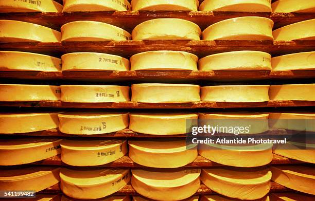 stacks of fontina cheese on shelves - courmayeur stock pictures, royalty-free photos & images