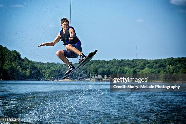 getting air on a wakeboard - wakeboarding stock pictures, royalty-free photos & images