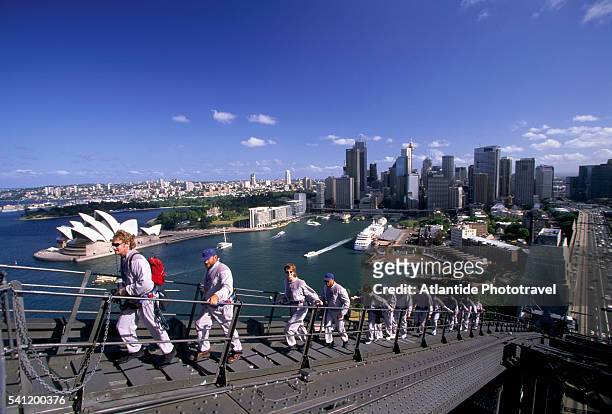 tourists climbing sydney harbour bridge - sydney harbour people stock pictures, royalty-free photos & images